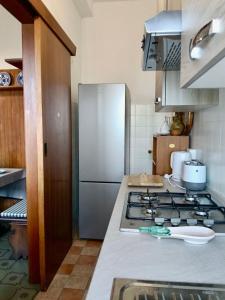 a kitchen with a stove and a refrigerator at La Terrazza sul Lago in Panicale