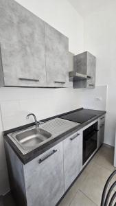 a kitchen with a sink and a stove at La Casa nella Rocca in Roccagloriosa