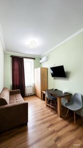 a living room with a couch and a table at Bank Hotel in Yeghegnadzor