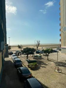 a row of cars parked in a parking lot near the beach at Sol e Praia in Figueira da Foz