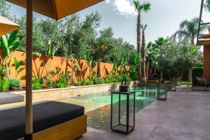 a swimming pool in a house with a resort at Villa Madjha Ecolodge Marrakech in Marrakesh