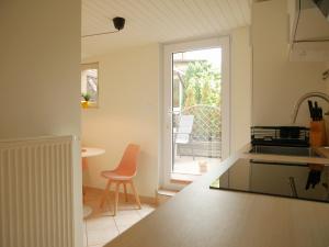 a kitchen with a counter and a table with a chair at Hafen Bungalow in Kirchdorf
