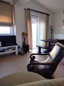 a living room with a table and a couch at Serenity Horizon Villa in Theologos