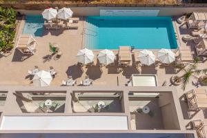 an overhead view of a pool with tables and chairs at Meramaglia Hotel in Malia
