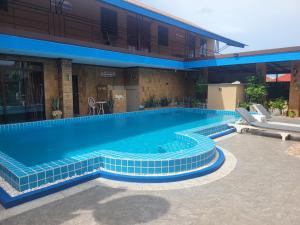 a large swimming pool with blue tiles in front of a building at Hua hin pool view in Hua Hin