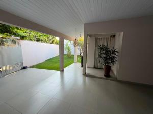 an empty room with a porch with a potted plant at Casa completa 3 quartos in Sinop