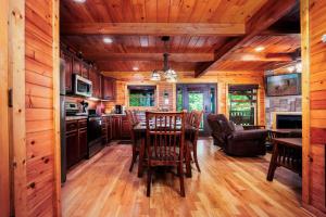 a kitchen and dining room with a table and chairs at Evening Star in Gatlinburg