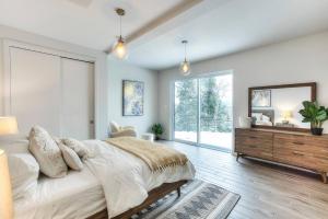 a bedroom with a large bed and a mirror at Tremblant Summit: Travel Experience Beyond Compare in La Conception