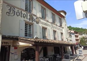 a building with a sign on the side of it at Logis Hotel Restaurant La Chaumière in Tournon-sur-Rhône