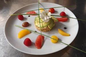a white plate with a dessert with fruit on it at Logis Hotel Restaurant La Chaumière in Tournon-sur-Rhône