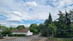 a street with trees and a cloudy sky at AGENCE MOMENT'APART Legend in Mouvaux