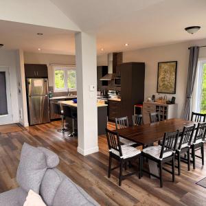 a kitchen and dining room with a table and chairs at Pool Table Private Beach - Breakfast Included - Fontainebleau in Labelle +31 photos