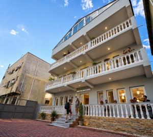 a building with people standing outside of it at Adventure Beach Hostal in Durrës