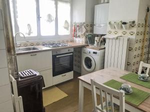 a kitchen with a sink and a stove and a table at Holiday Home Nicol by Interhome in Trarego +20 photos