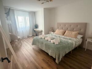 a bedroom with a large bed with two pillows on it at El rincón de armanyá in Lugo