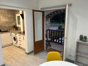 a kitchen with a door leading to a balcony at Cal Botey in Ripoll