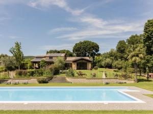a villa with a swimming pool in front of a house at Holiday Home Rosalba Bacara by Interhome in Bolsena