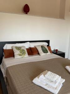 a bedroom with a large bed with pillows at Tenute Cinquanta in Menfi
