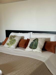 a bed with several pillows on top of it at Tenute Cinquanta in Menfi