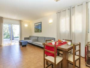 a living room with a table and a couch at Holiday Home Bretos by Interhome in Fonts