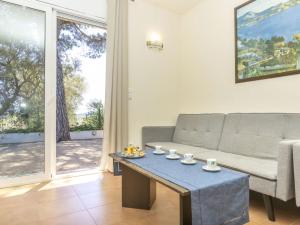 a living room with a couch and a table at Holiday Home Bretos by Interhome in Fonts