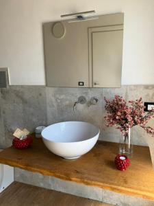 a bathroom with a large white bowl sink on a counter at Tenute Cinquanta in Menfi