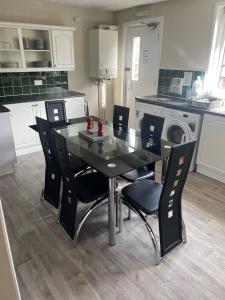 a dining room table and chairs in a kitchen at Winmar Guesthouse in Inverness