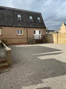 an empty parking lot in front of a house at Winmar Guesthouse in Inverness