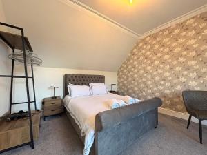 a bedroom with a bed and a couch in it at Winmar Guesthouse in Inverness +3 photos