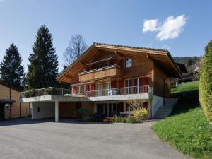 a wooden house with a balcony and a driveway at Apartment Chalet Almisgässli by Interhome in Grindelwald