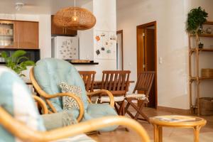 a living room with two chairs and a table at Casa da Maresia - The Seaside Escape in Paul do Mar