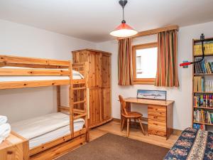 a bedroom with two bunk beds and a desk at Apartment Chesa Dal Luf B5 by Interhome in Silvaplana