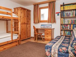 a bedroom with a bunk bed and a desk at Apartment Chesa Dal Luf B5 by Interhome in Silvaplana +28 photos