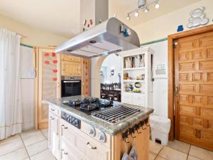 a kitchen with a stove top oven in a room at Holiday Home Mirada al Sol by Interhome in Moraira