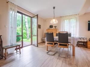 a living room with a table and chairs and a dining room at Holiday Home Borowikowa by Interhome in Sasino