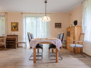 a dining room with a table and chairs at Holiday Home Borowikowa by Interhome in Sasino +18 photos