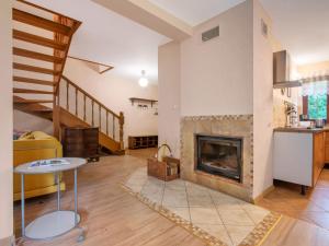 a living room with a fireplace and a staircase at Holiday Home Borowikowa by Interhome in Sasino