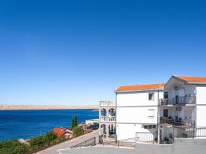 a white building with a view of the ocean at Apartment Delfin-7 by Interhome in Cesarica
