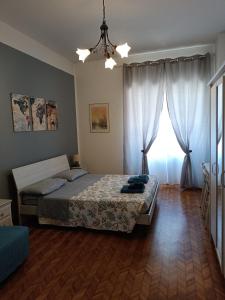 a bedroom with a bed and a large window at Il Papavero Nero in Rome