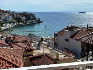 a view of the ocean from the roofs of buildings at "Thea" Apartment 1 in Skala Marion