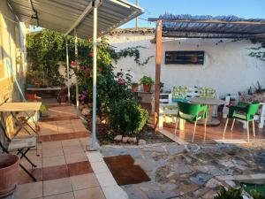 a patio with a table and chairs under a pergola at Casa El Filali in Villaminaya