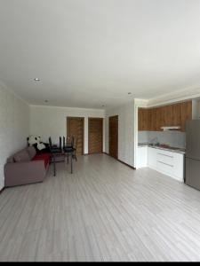 a living room with a couch and a table at Novel Hotel&Apartaments in Korumdy