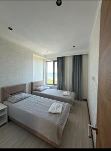 a hotel room with two beds and a window at Novel Hotel&Apartaments in Korumdy