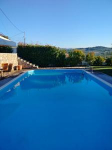a swimming pool in a villa with a view at Serenity Horizon Villa in Theologos