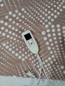 a white cell phone is plugged into a polka dot at Mr Deang shop Doi Inthanon bird center in Ban Na Yang