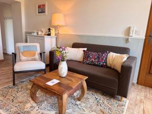 a living room with a couch and a coffee table at Portail Sainte Marie in Montbrun-les-Bains