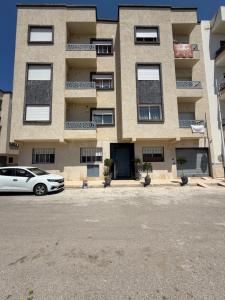 a building with a car parked in front of it at Location meublée Martil in Martil