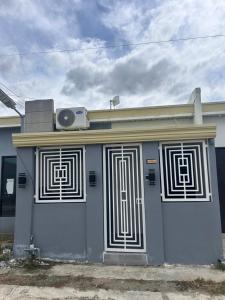 a house with a door with a speaker on top at DG Luxe Suites - Cabanatuan in Bangad