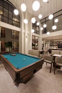 a pool table in a large room with chairs at The Dyastana Umalas in Kerobokan
