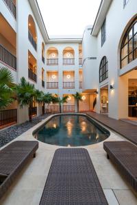 an indoor pool in the courtyard of a building at The Dyastana Umalas in Kerobokan